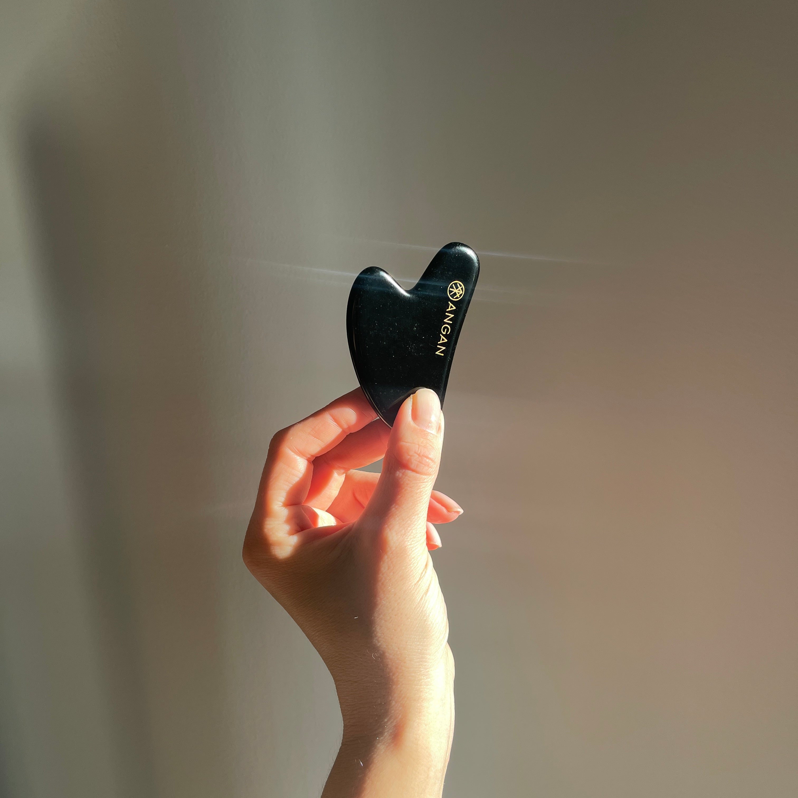 ANGAN Obsidian Gua Sha — ancient facial massage technique for sculpted, glowing skin