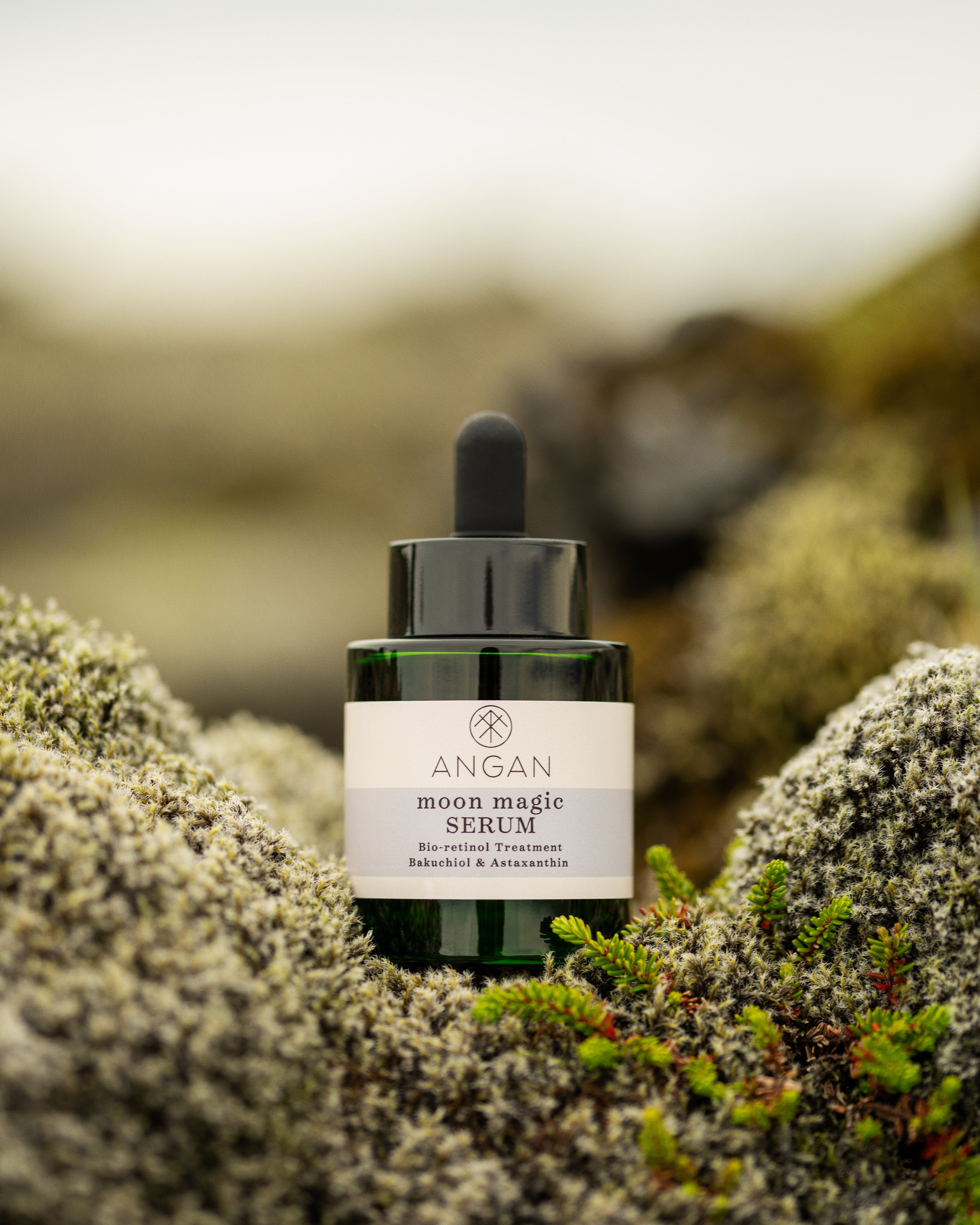 ANGAN Moon Magic Bio-Retinol Serum — bottle on mossy Icelandic landscape
