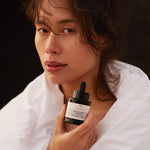ANGAN Moon Magic Serum — model using serum in evening ritual