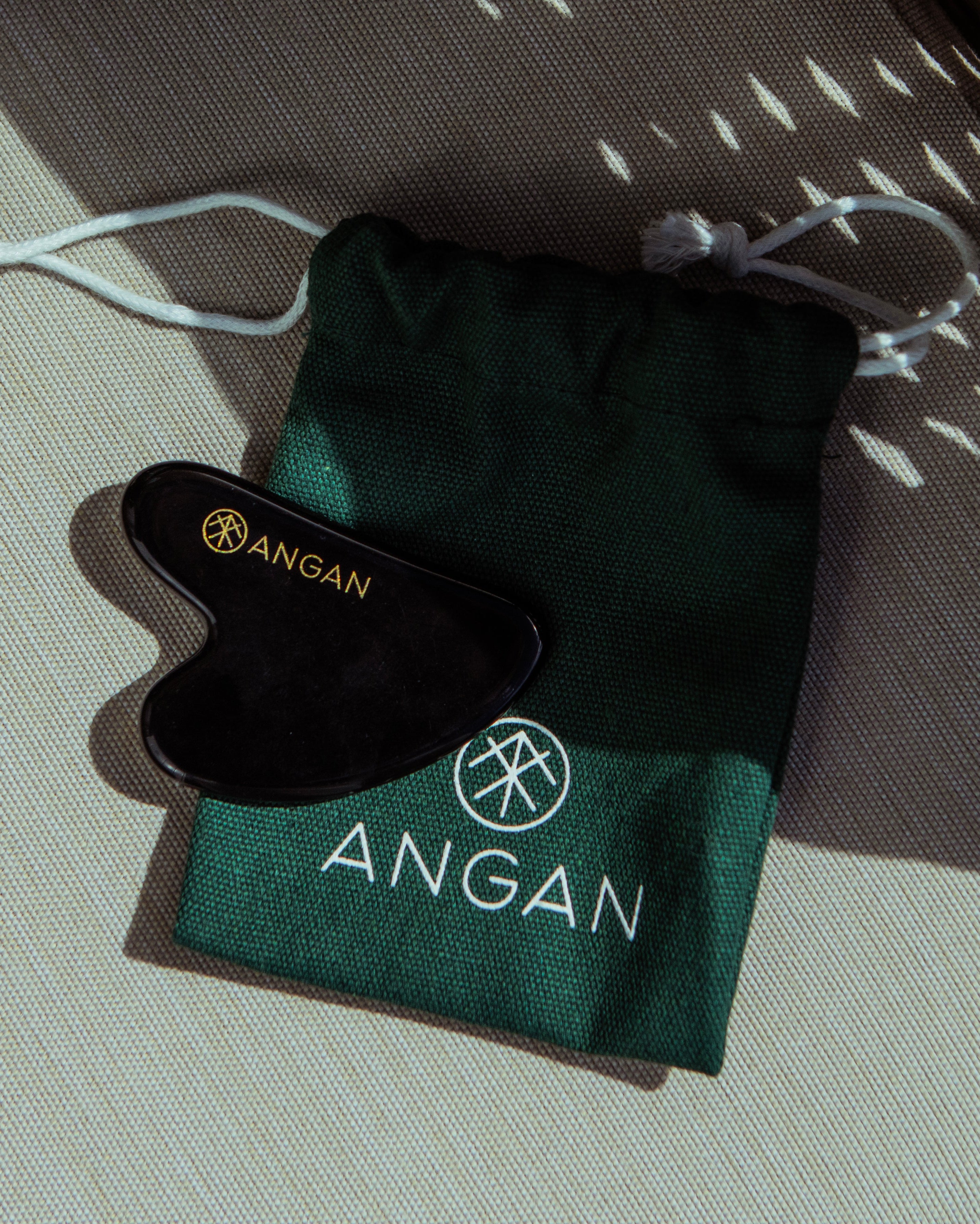 ANGAN Obsidian Gua Sha — outdoors in Icelandic sunshine