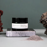 ANGAN Black Lava Face Mask — multiple jars on Icelandic landscape