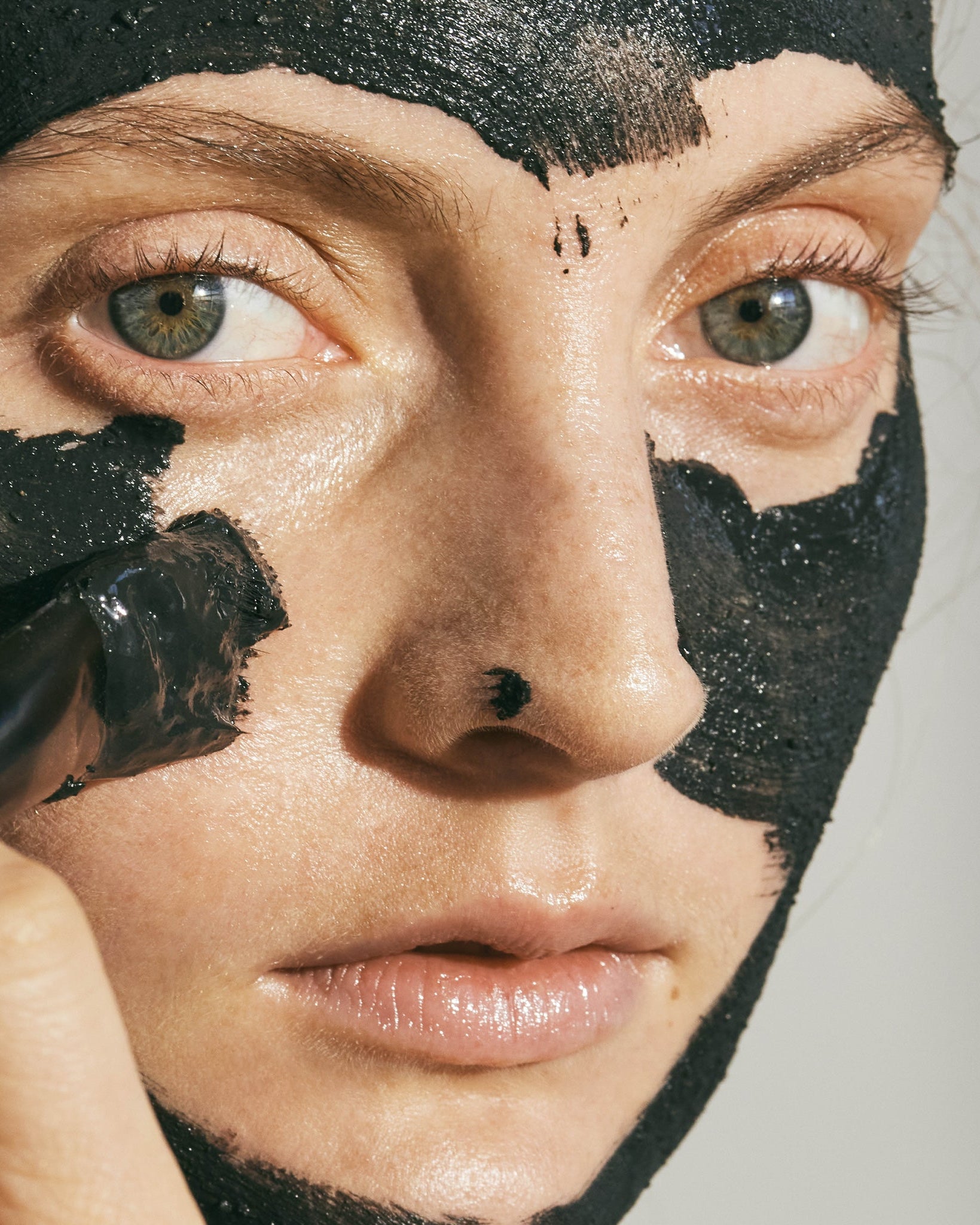 ANGAN Black Lava Face Mask — open jar showing volcanic clay texture